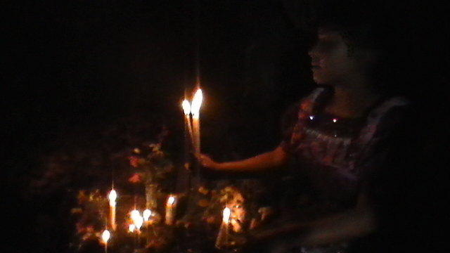 Fig. 11. Petrona Tzunux Chivalan offering candles in Paxil.JPG