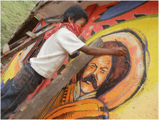Photo11-A Zaptista boy co-painting the Pancho Villa mural .jpg